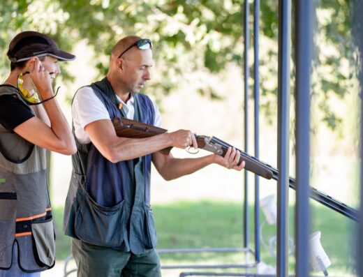 Skeet shooting instructor coaching a student